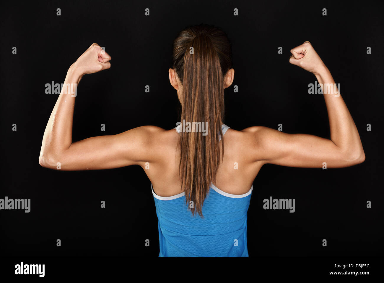 Woman flexing her muscles and showing her toned back Royalty-Free Stock  Image - Storyblocks