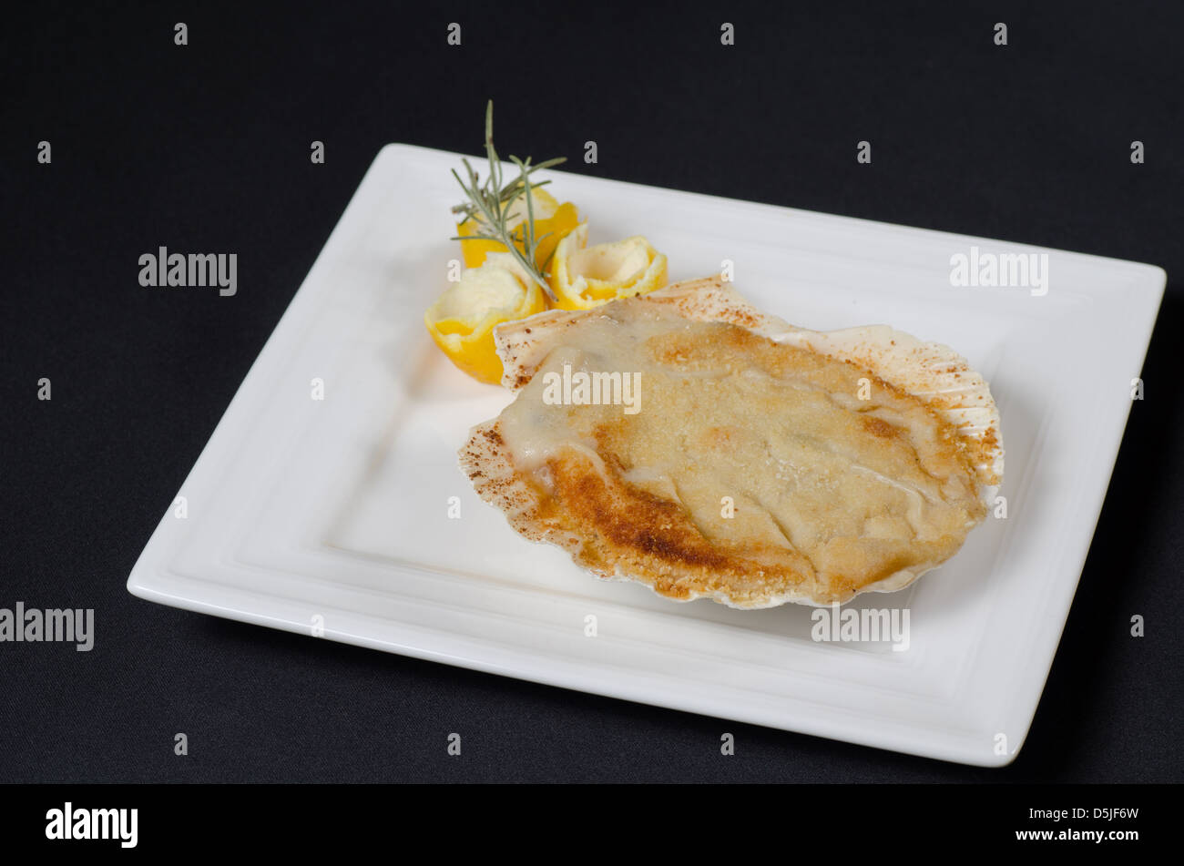 Filled scallop shell au gratin, a delicious starter Stock Photo Alamy
