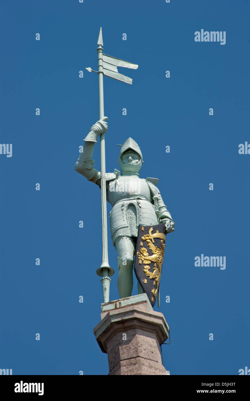 Knight with shining armor with pylon and shield Stock Photo