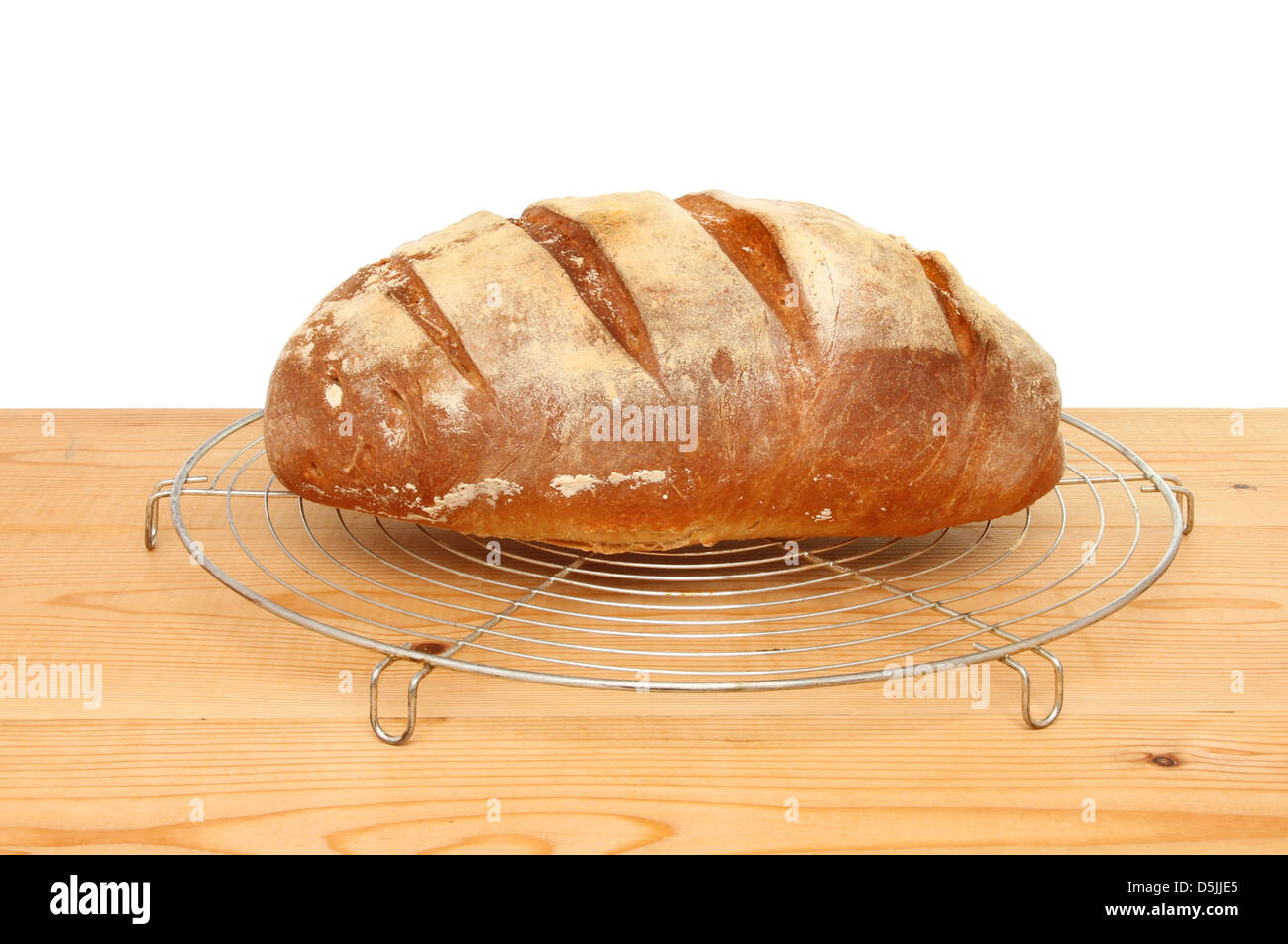Freshly baked bloomer loaf on a cooling rack Stock Photo