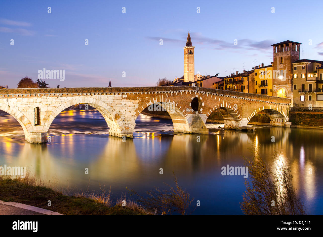Ponte Pietra over Adige River at evening, built by the Romans in 100 BC. Stock Photo