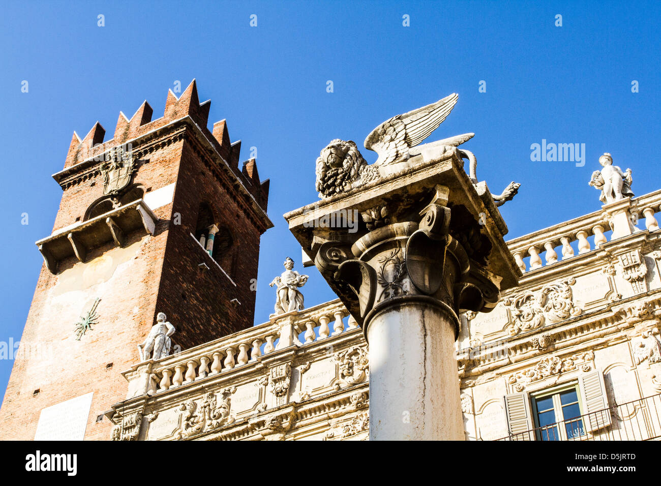 Column with the Lion of Saint Mark and Palazzo Maffei in the backgound at Piazza delle Erbe. Stock Photo