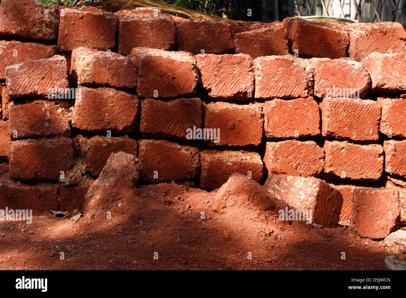 Pile of house bricks by the roadside in Vagator, North Goa, India Stock
