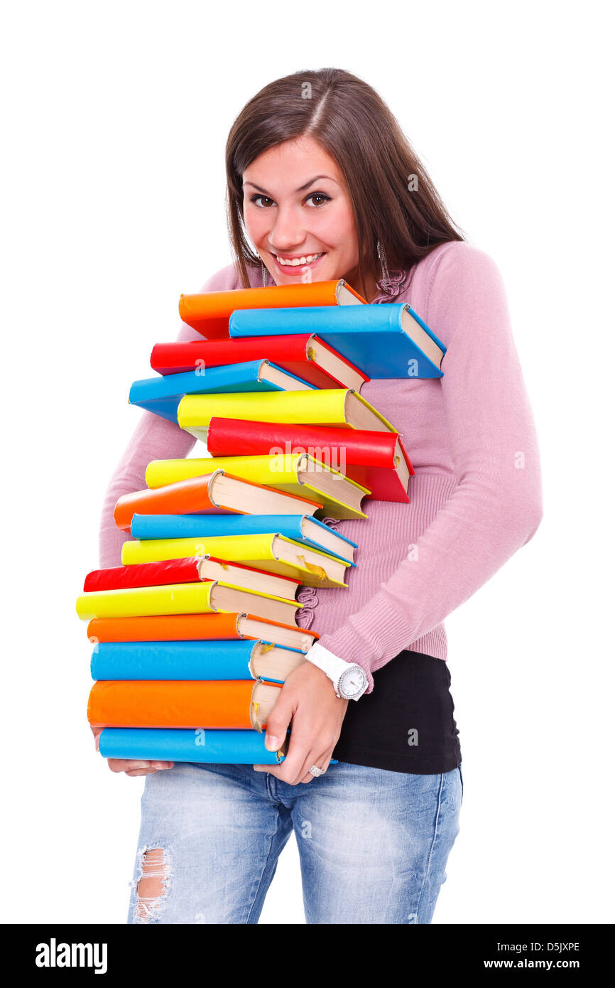 Joyful girl holds a lot of books, being careful not to drop them. Stock Photo