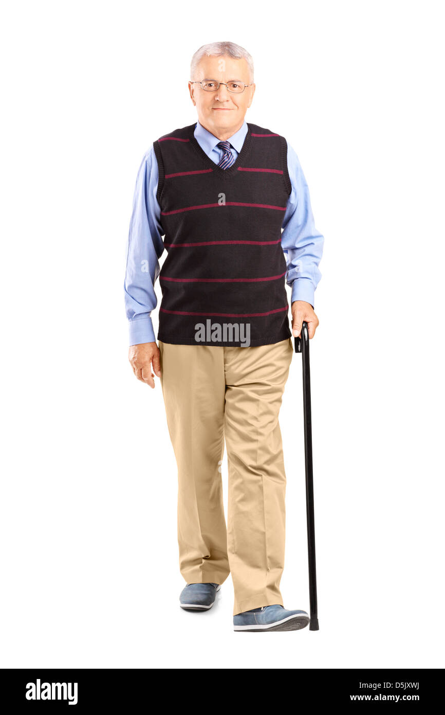 Full length portrait of a senior man walking with a cane, isolated on