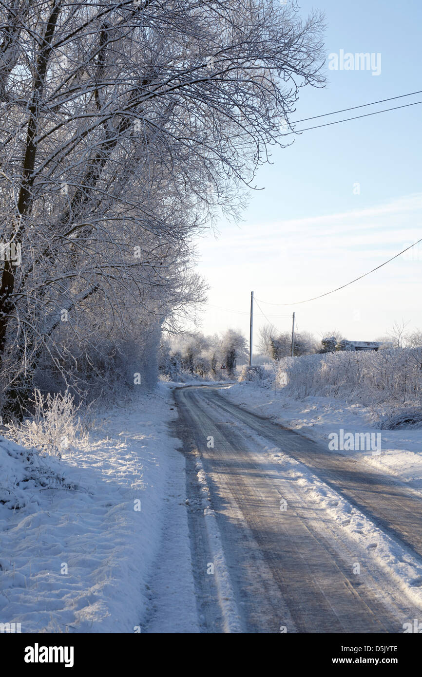 Narrow country road in winter in Norfolk UK Stock Photo