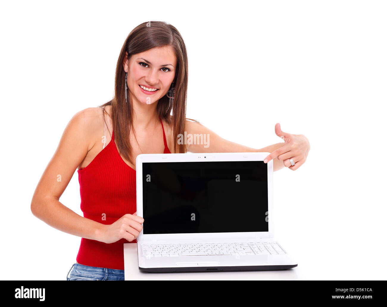 Portrait of a smiling girl showing laptop to the camera over white ...