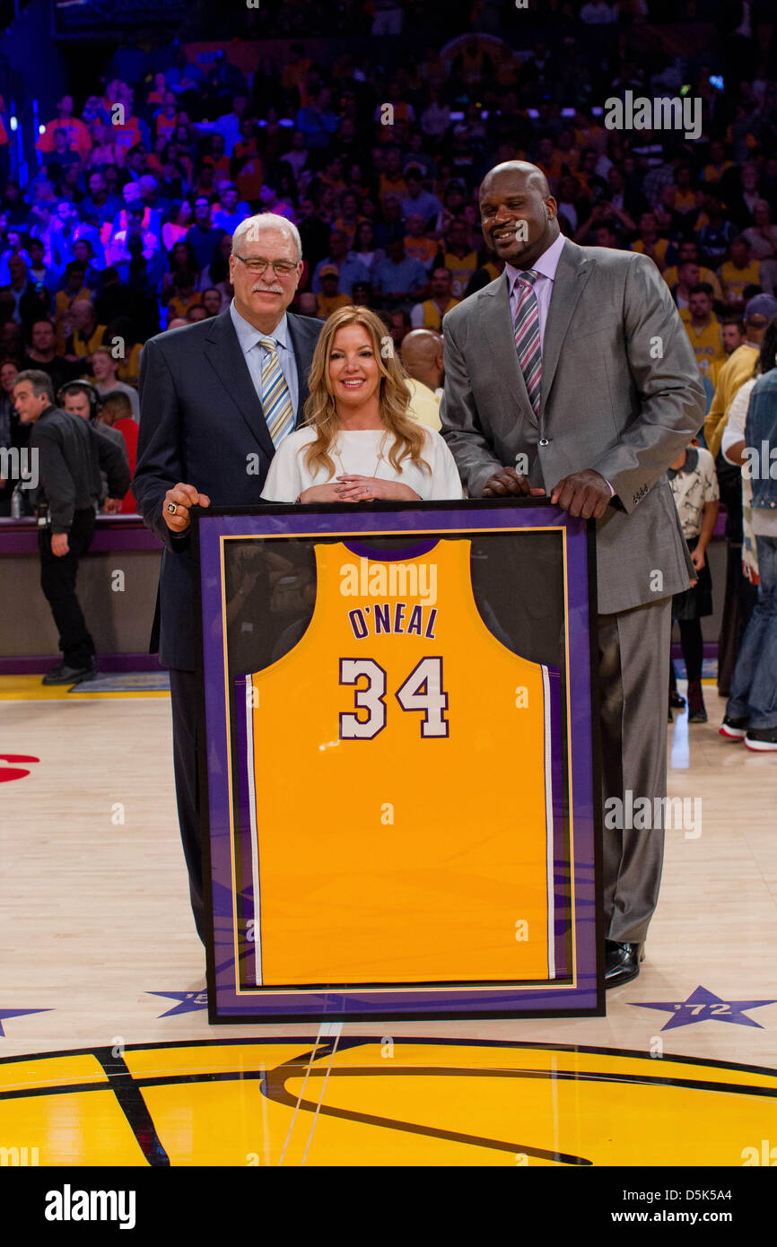 Los Angeles, California, USA. 2nd April 2013. Shaquille O'Neal, right, poses with Jeanie Buss and Phil Jackson with his framed jersey during the jersey retirement ceremony for retired Los Angeles Lakers center (34) Shaquille O'Neal during halftime of  the Lakers 101-81 victory over the Dallas Mavericks at the STAPLES Center in Los Angeles, CA. Credit: Action Plus Sports Images / Alamy Live News Stock Photo