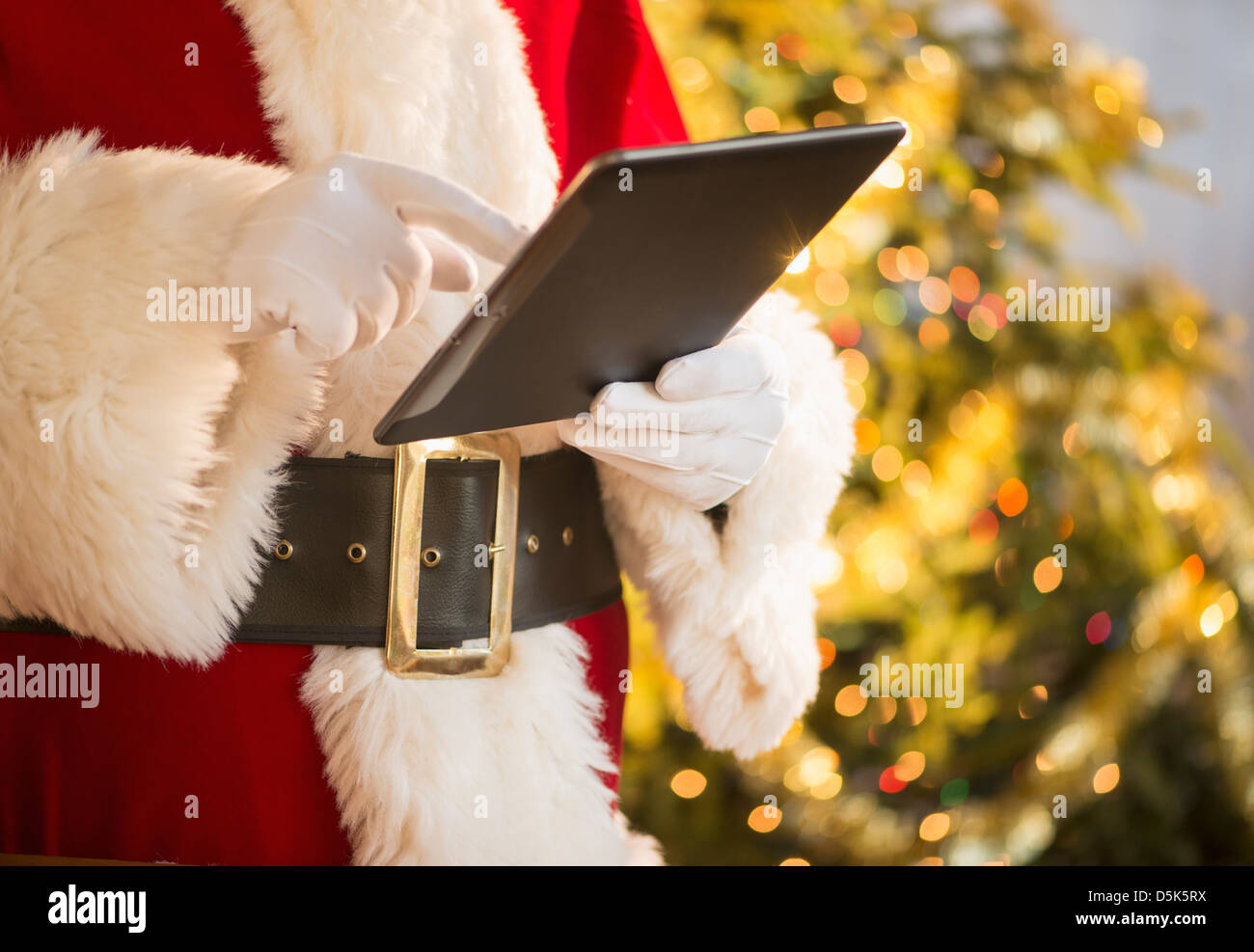 Santa claus holding digital tablet Stock Photo - Alamy