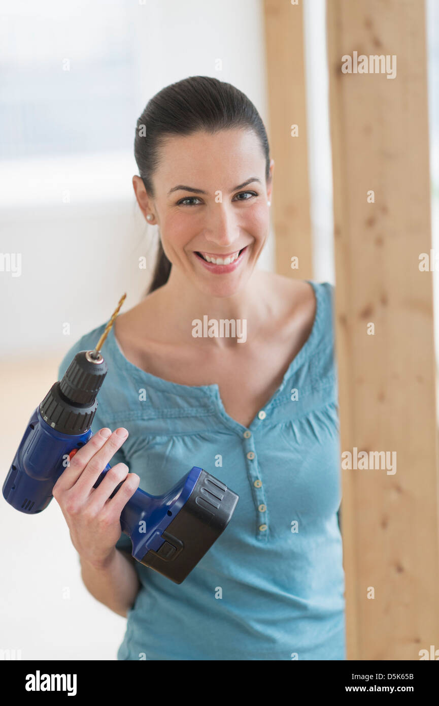 Portrait of woman using hand drill Stock Photo Alamy