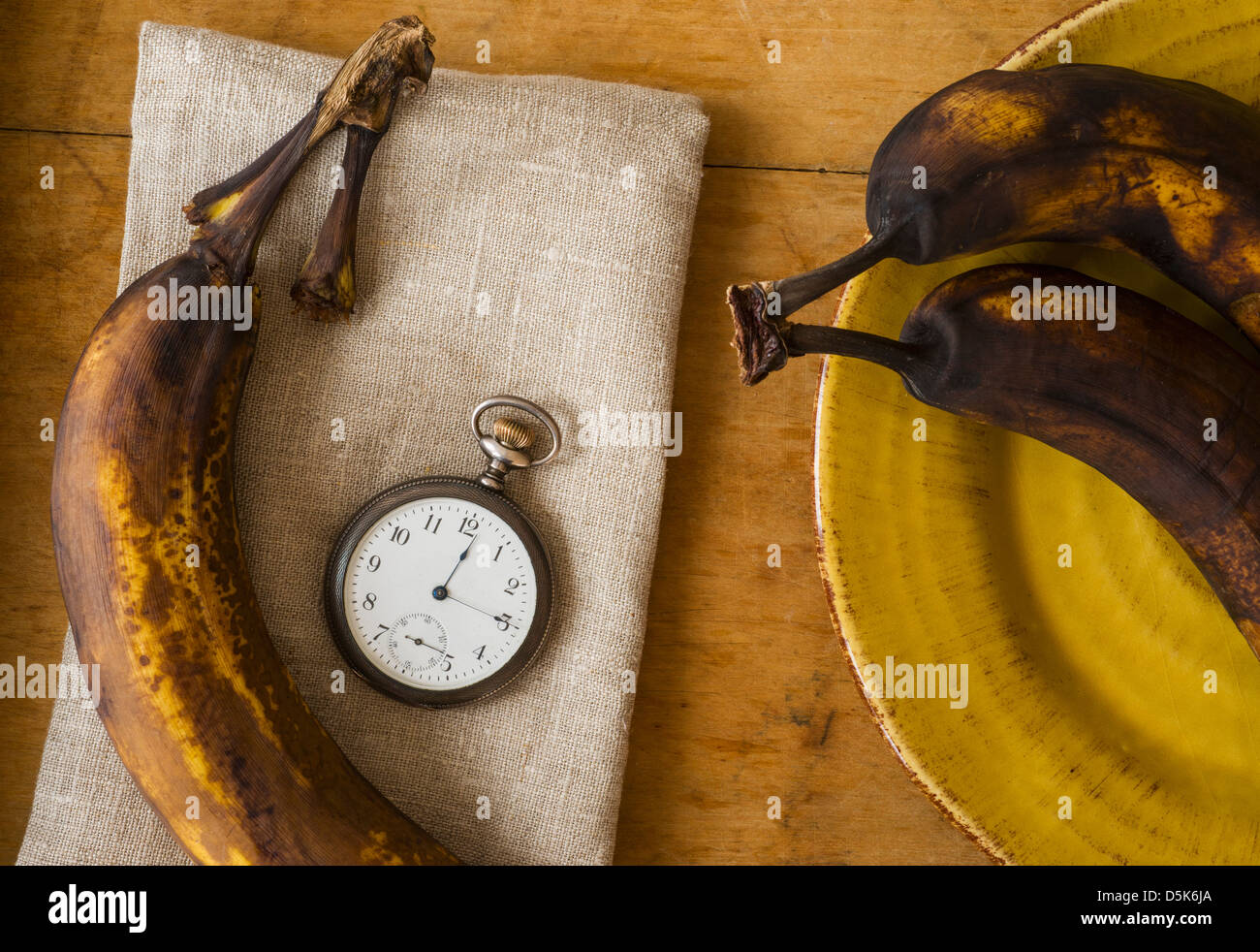 Still life with bananas and pocket watch Stock Photo