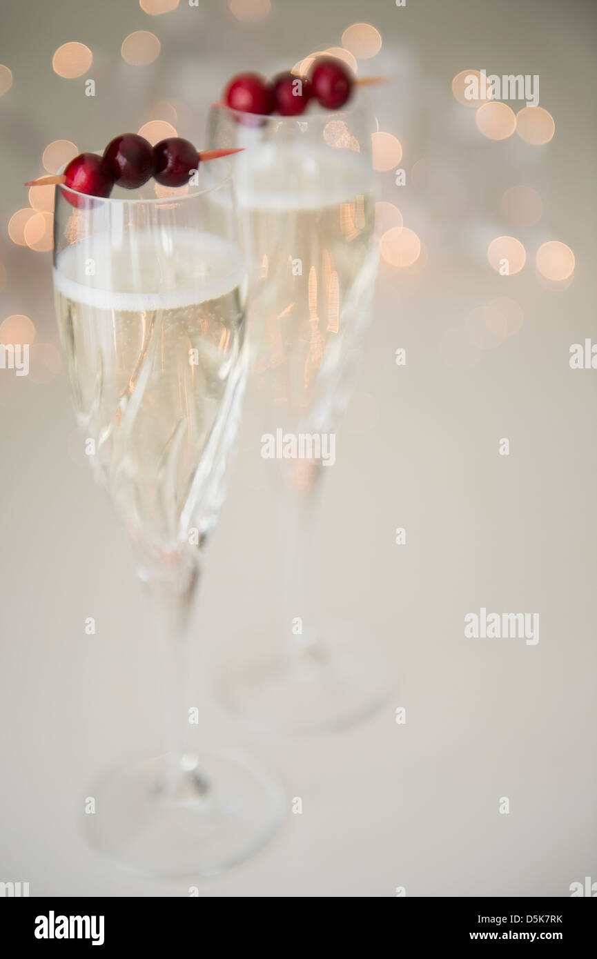 Champagne with cranberry garnish Stock Photo