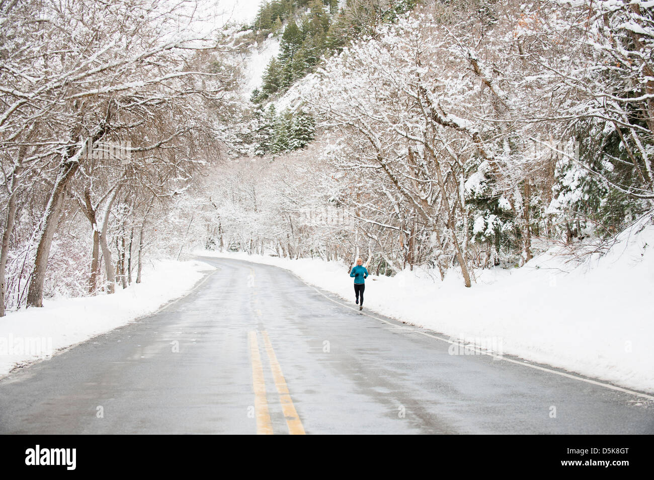 USA, Utah, Salt Lake City, Woman jogging in winter Stock Photo