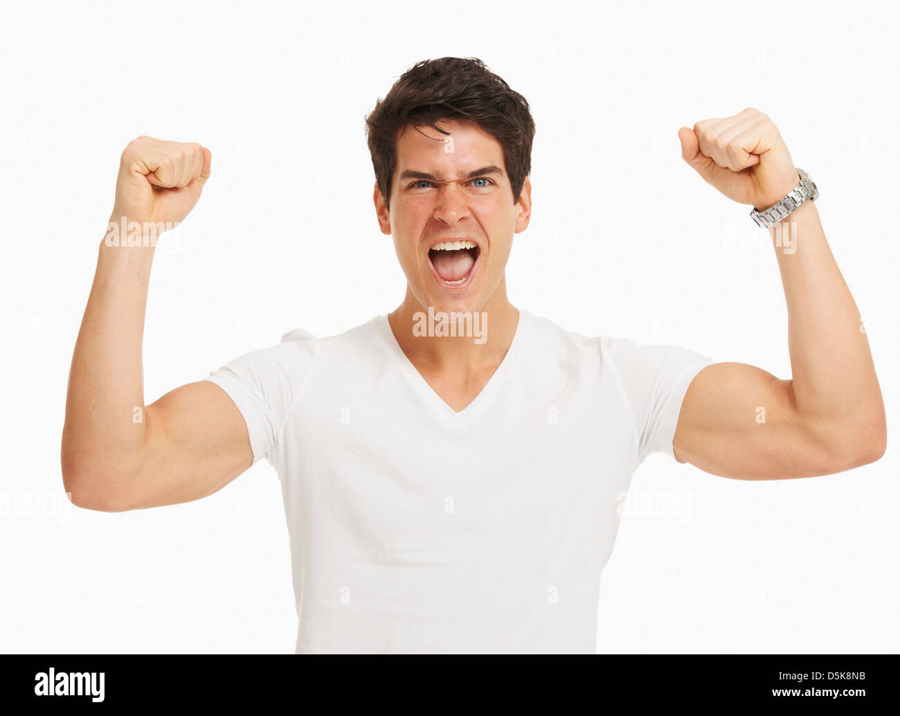 Studio portrait of handsome man cheering and flexing muscles Stock Photo