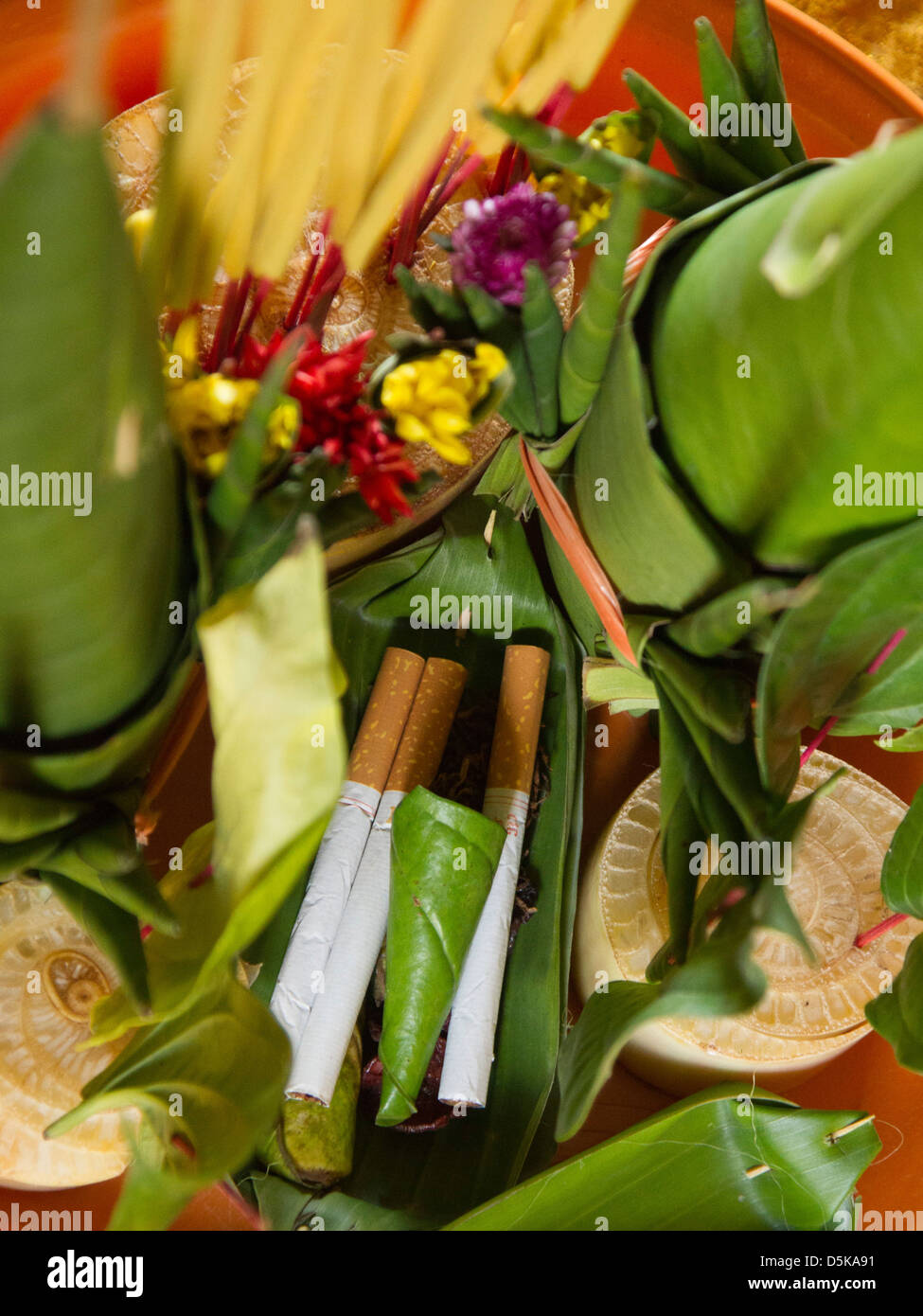 Buddhist temple offering in Cambodia - even the gods need cigarettes Stock  Photo