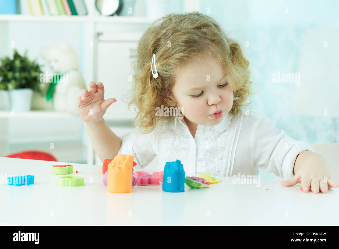 Little girl modeling with clay at kindergarten Stock Photo Alamy