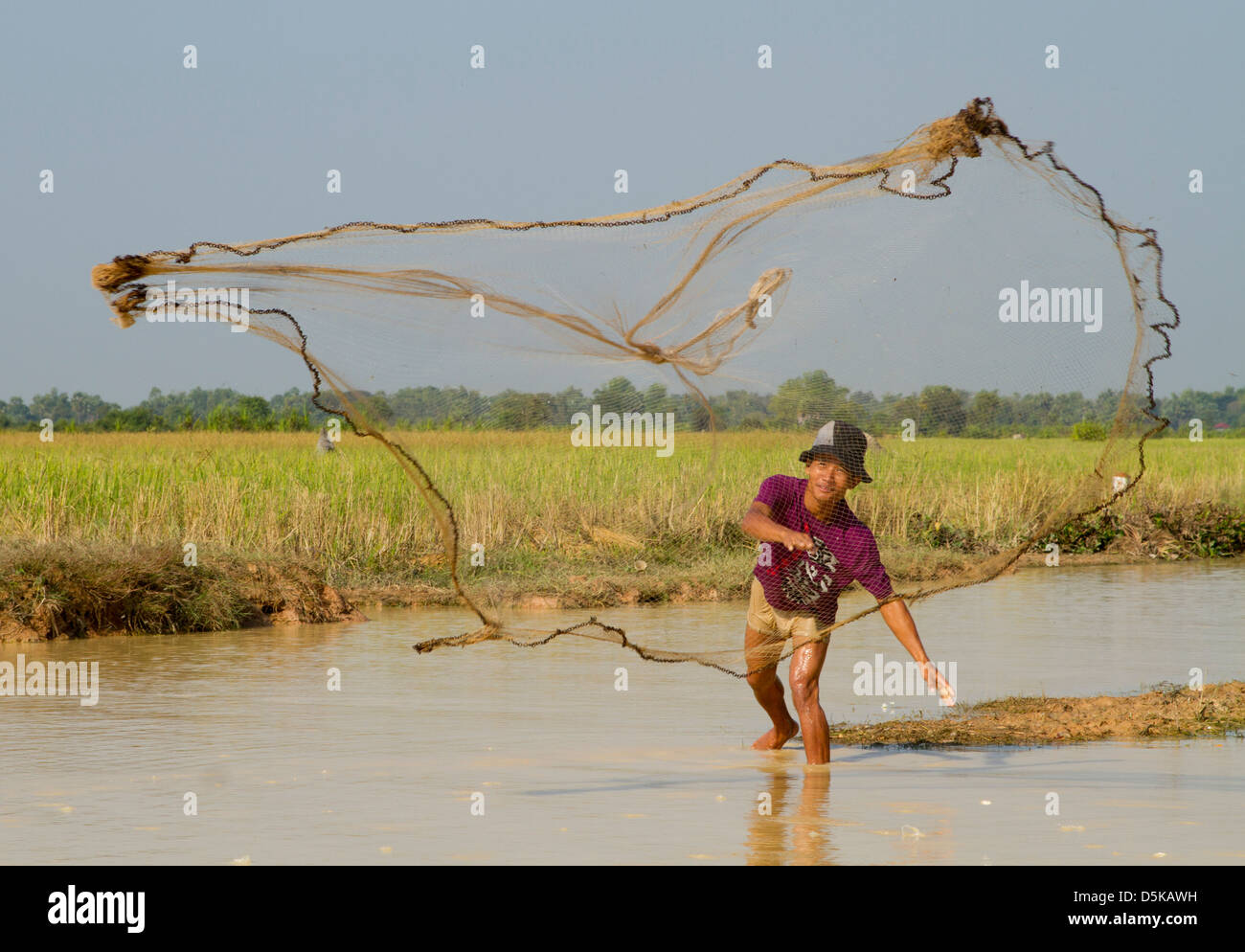 Casting a fishing net in Cambodia Stock Photo Alamy