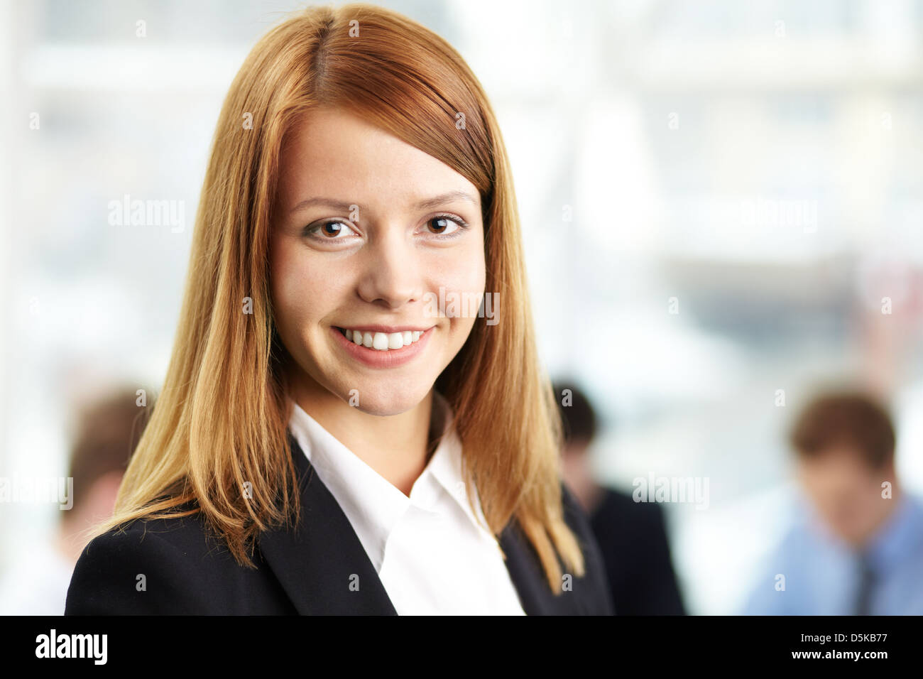 Portrait of young smiling businesswoman looking at camera Stock Photo ...