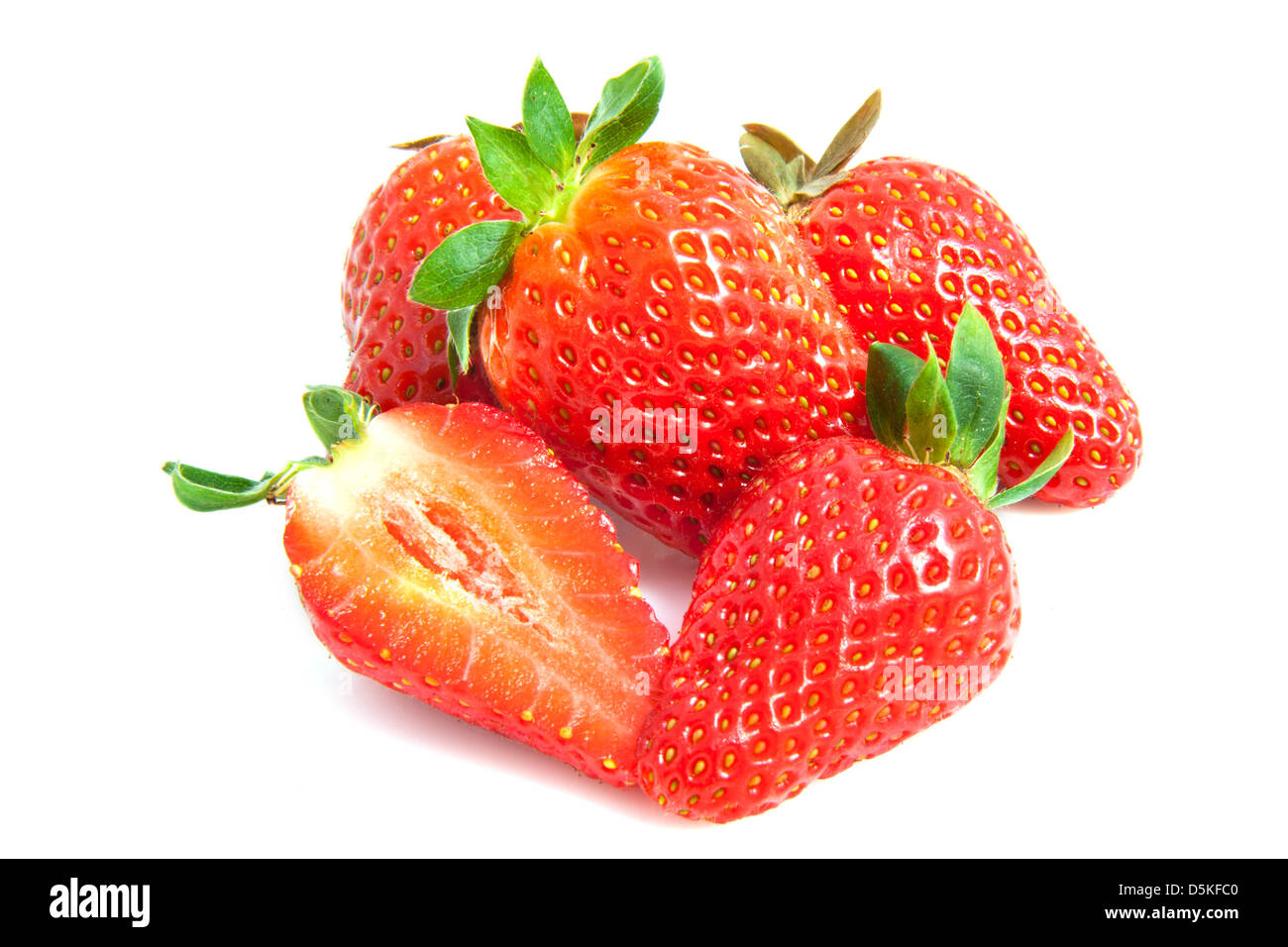 Strawberries on a pile isolated over white Stock Photo - Alamy