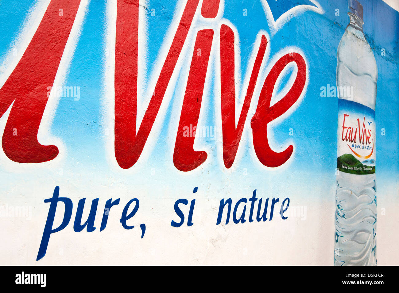 Madagascar, Nosy Be, Hell-Ville, Eau Vive bottled water advertisement hand painted on wall Stock Photo