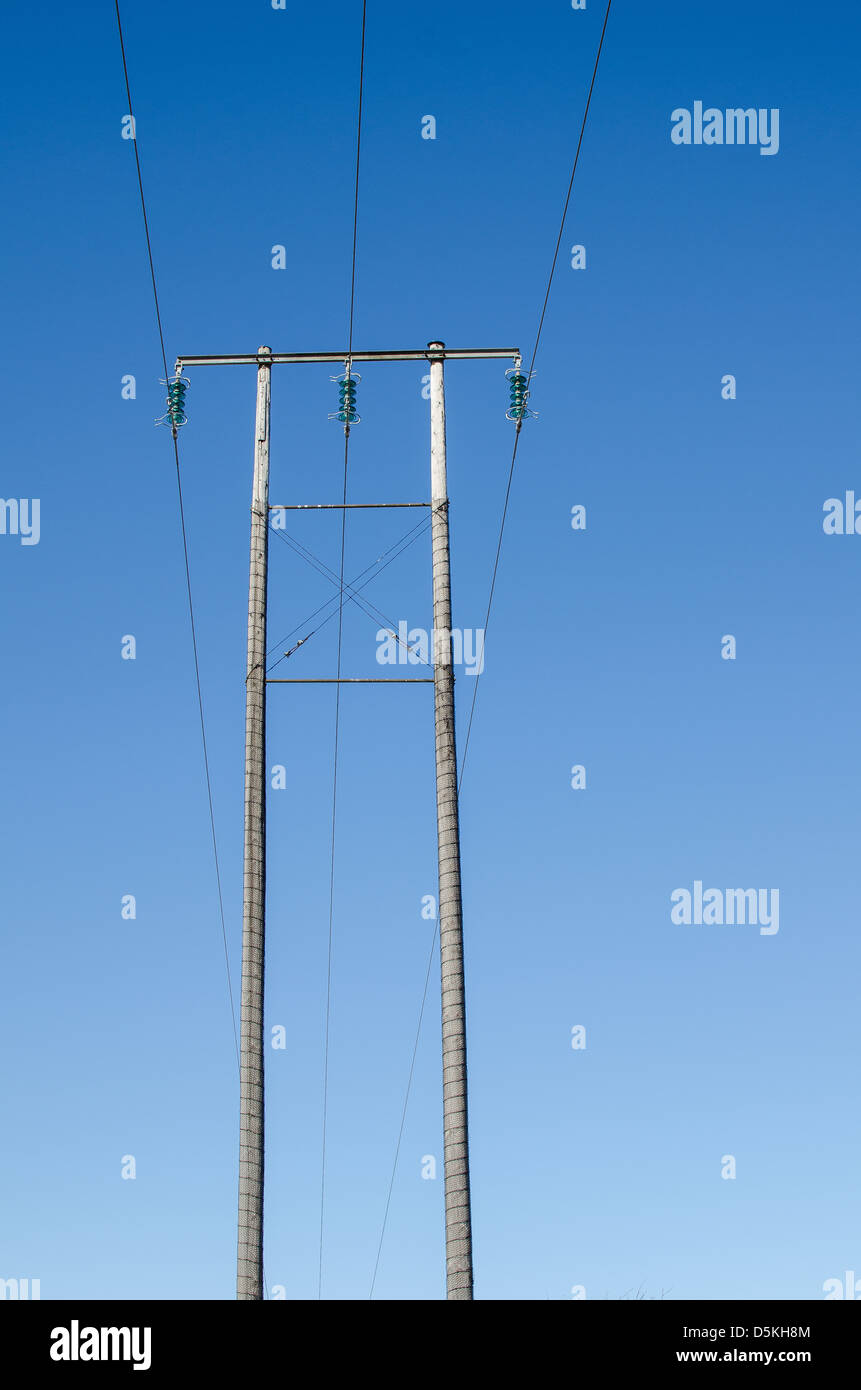 Three electric lines at two poles Stock Photo