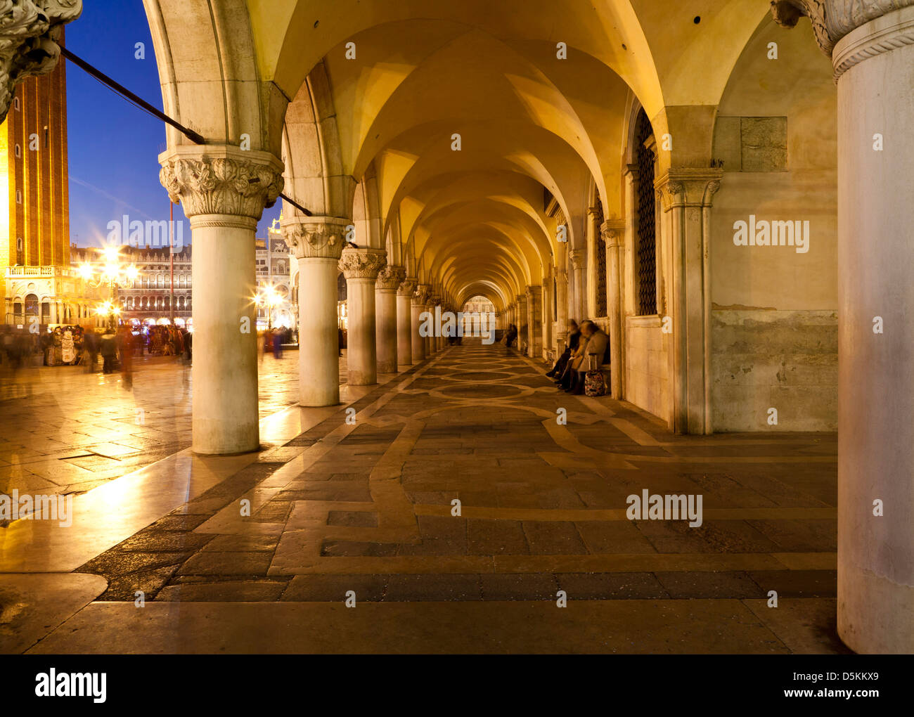 Venice at night. St Mark's Square. Colonnade and arches. People in the square Stock Photo