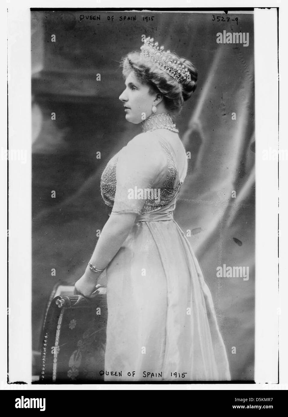 This photograph features Queen Victoria of Spain, captured in 1915. She is depicted wearing a crown and tiara, showcasing her royal attire and status during her reign. Stock Photo