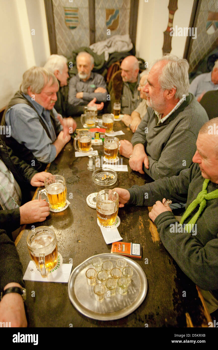 Prague - friends in a traditional Czech pub drinking beer. Stock Photo