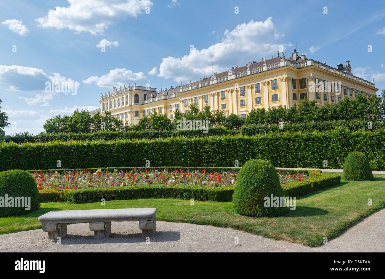 Area before Schonbrunn Palace (build 16-17 century) with blossoming flowers on lawn. Vienna, Austria. Stock Photo