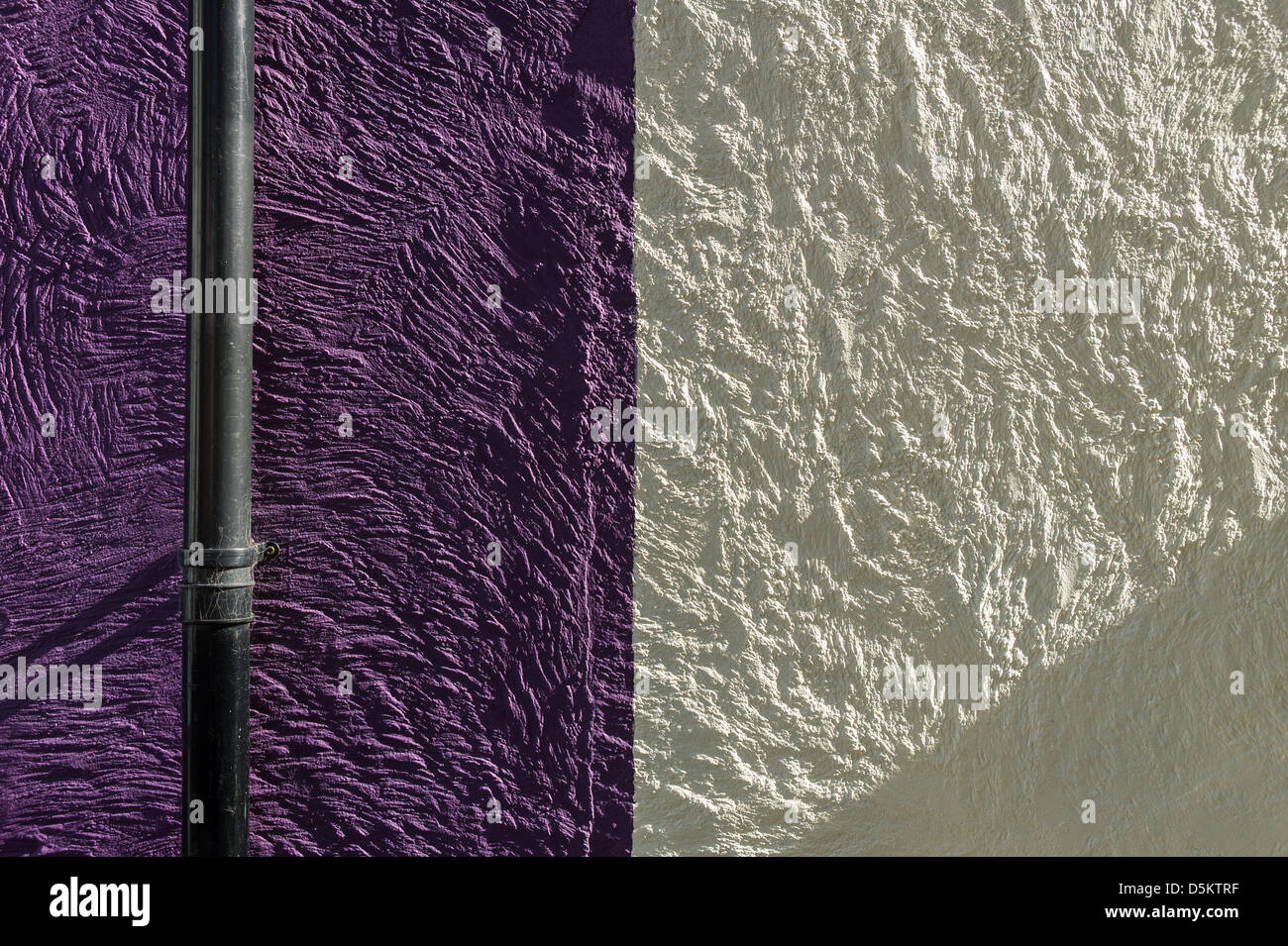 Abstract section of wall with two colour coating and down-pipebackground Stock Photo