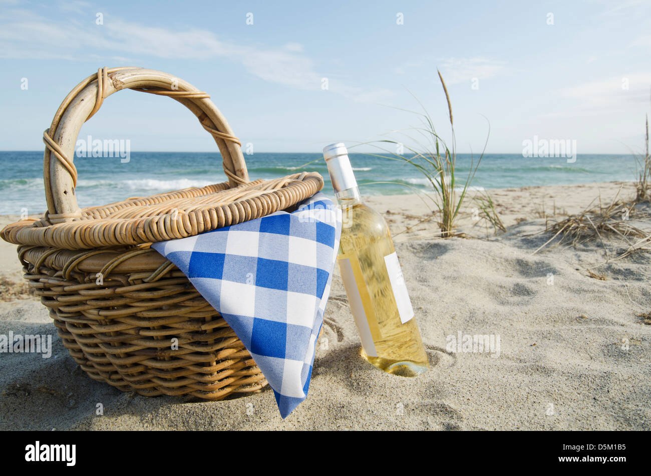 Picnic basket and white wine on beach Stock Photo - Alamy