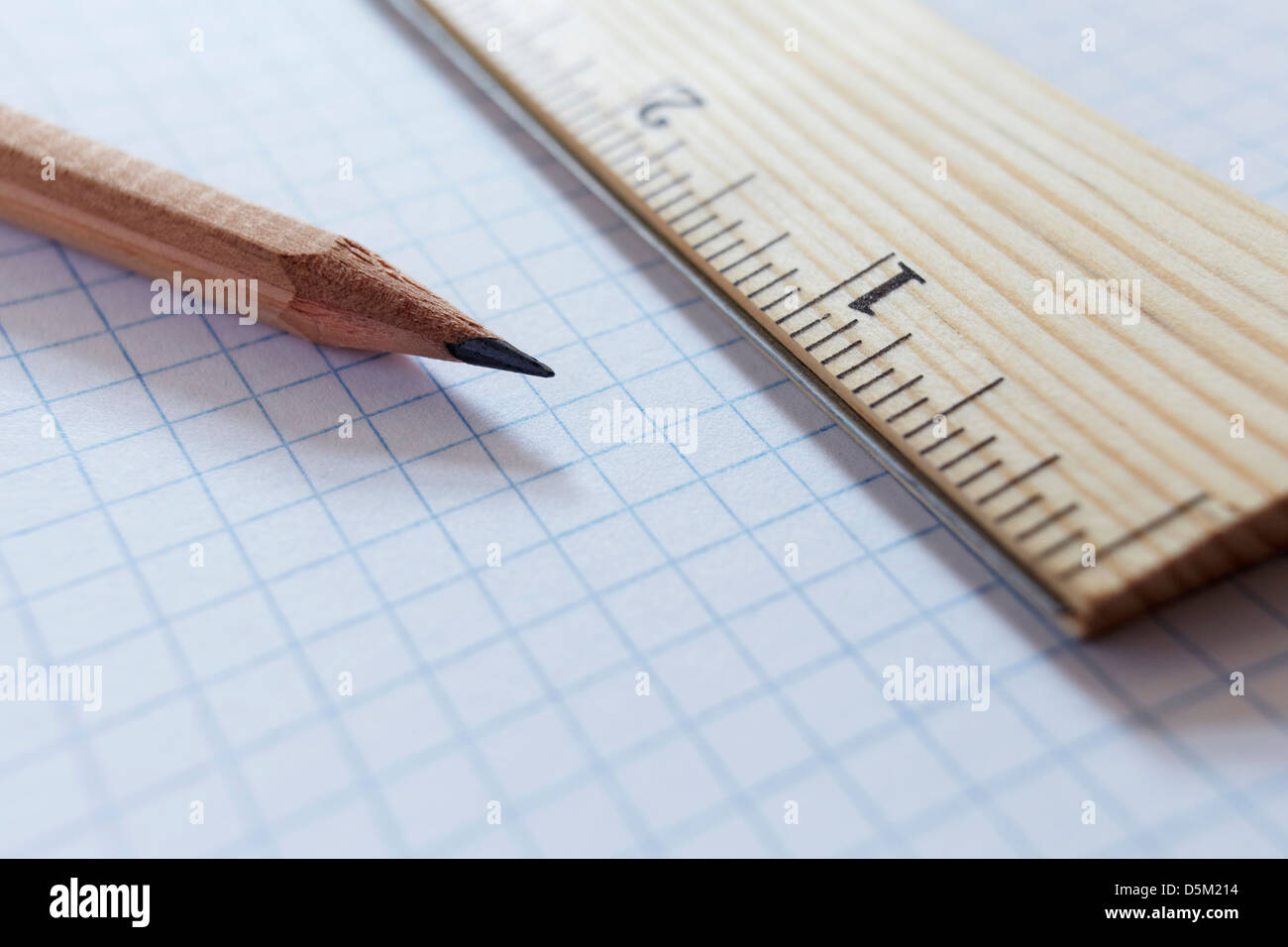 Ruler and pencil on graph paper, studio shot Stock Photo