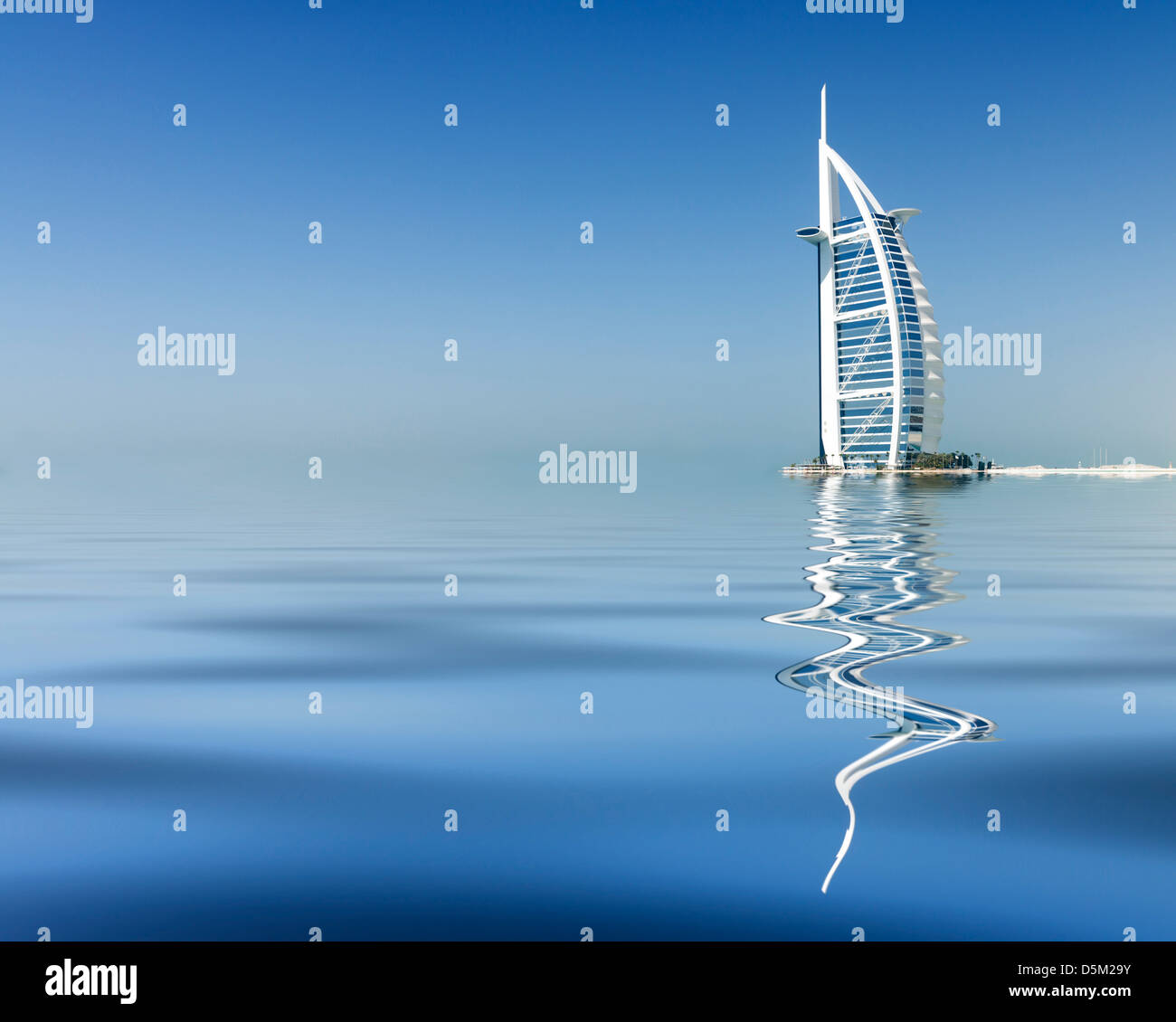 Reflection of luxury Burj al Arab Hotel on beach front in Dubai United Arab Emirates UAE Stock Photo