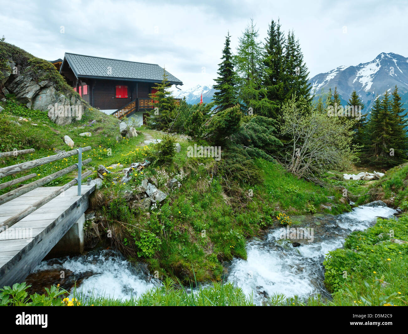 Mountain Bettmeralp village summer cloudy view with small brook (Switzerland) Stock Photo