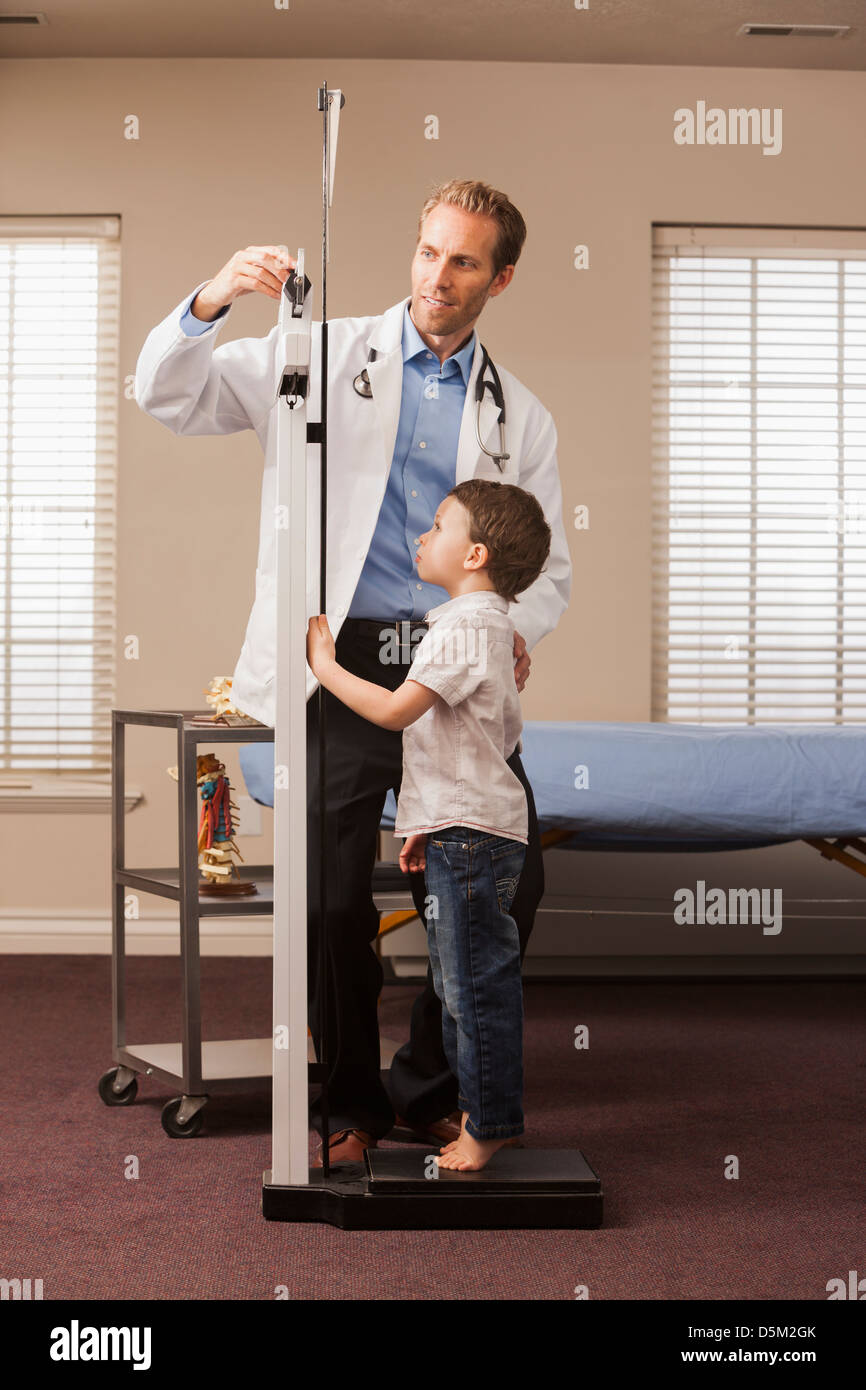Boy (2-3) on scale in doctor's office Stock Photo