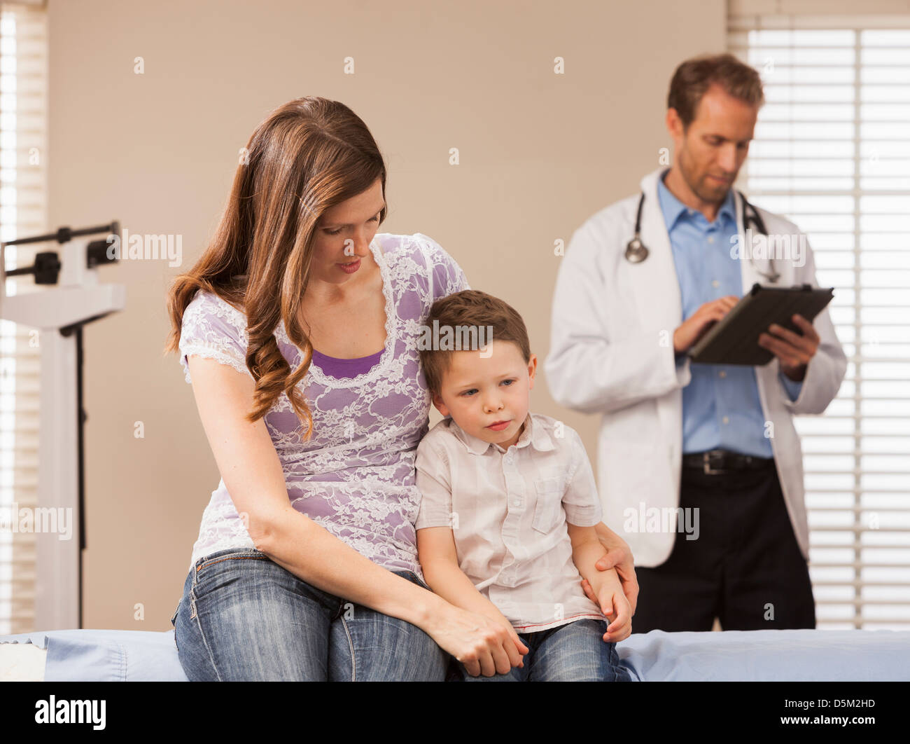 Mother with son (2-3) in doctor's office Stock Photo