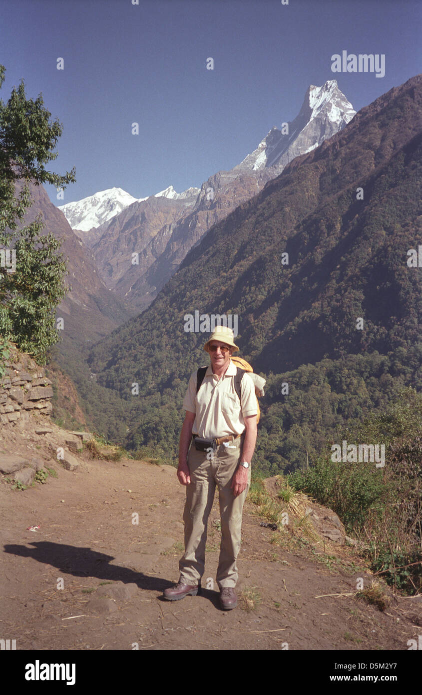 Trekker David Keith Jones near Chomrong on Annapurna circuit with peaks of range Gangapurna Annapurna II and Machhapuchhre Stock Photo