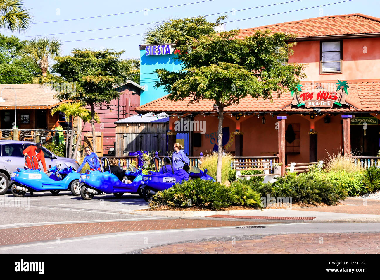Little tourist trikes parked outside a bar on Siesta Key Island Florida Stock Photo
