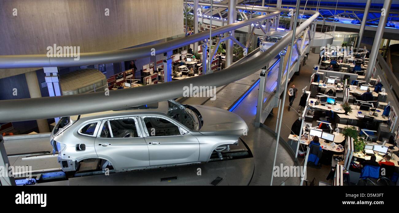 BMW body shells are transported along the assembly line above the heads ...