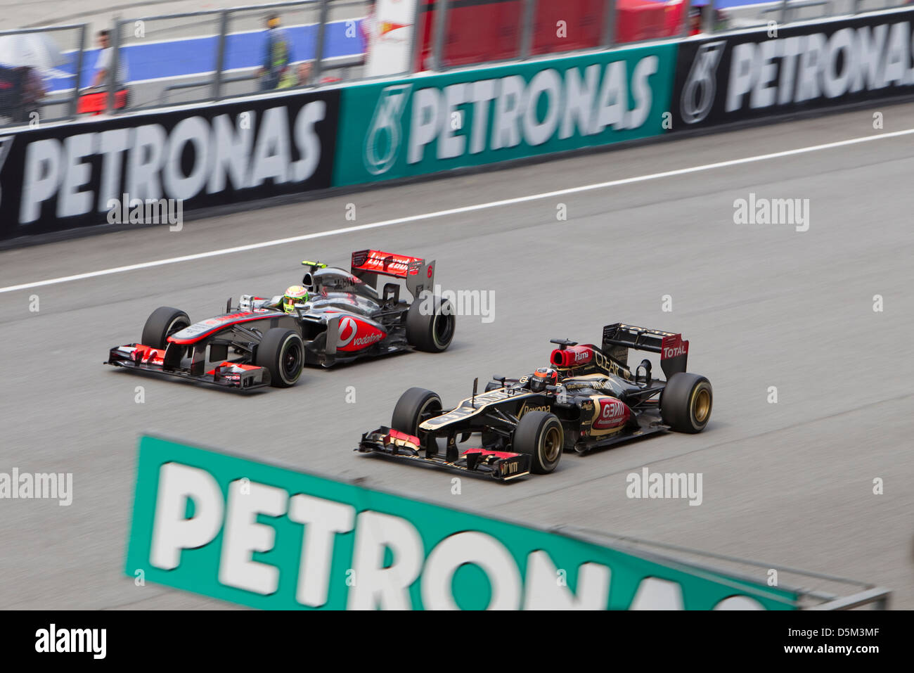 Kimi Raikkonen of Lotus F1 Team overtakes McLaren at the Malaysian F1 GP Stock Photo