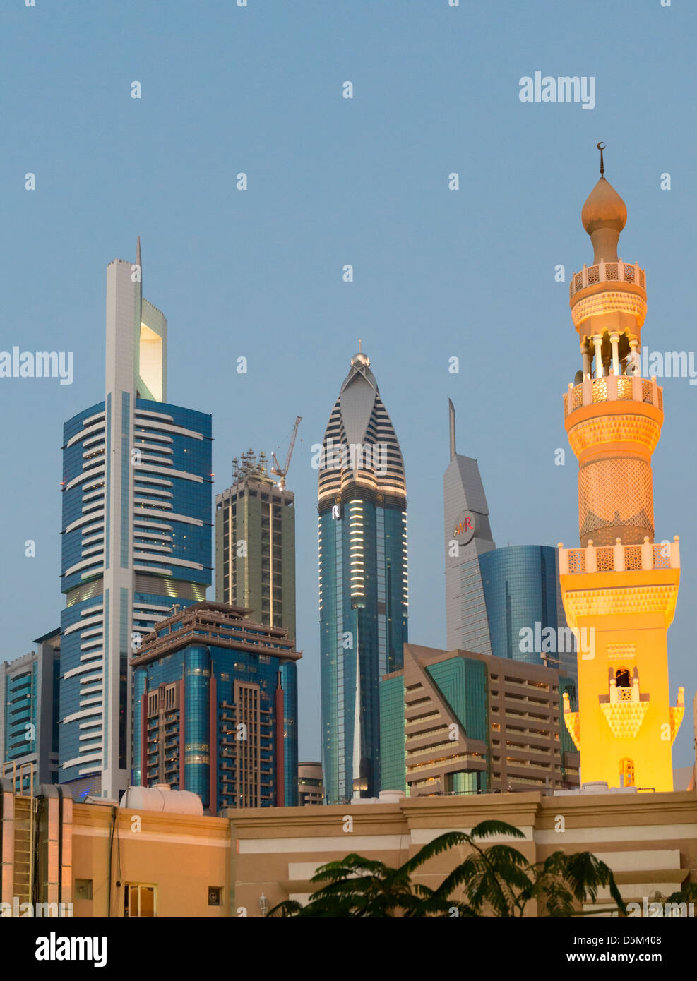 Mosque minaret and skyline of skyscrapers in Dubai United Arab Emirates UAE Stock Photo