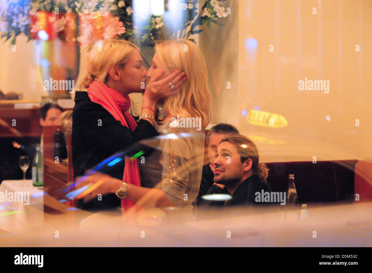 David Garrett watching as his two female companions kiss each other at Borchardt restaurant. Berlin, Germany - 27.04.2011 Stock Photo