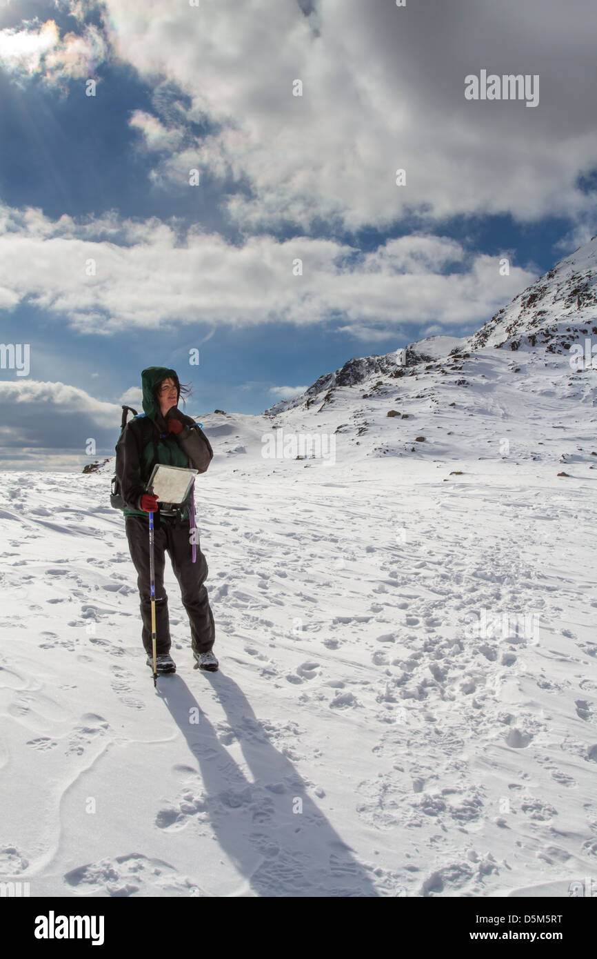 Female hill walker person taking in breathtaking views heading towards Bowfell from Rosset Pike Stock Photo