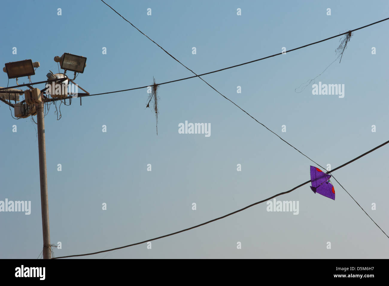 Kites caught on overhead power lines. Varanasi, India. Stock Photo