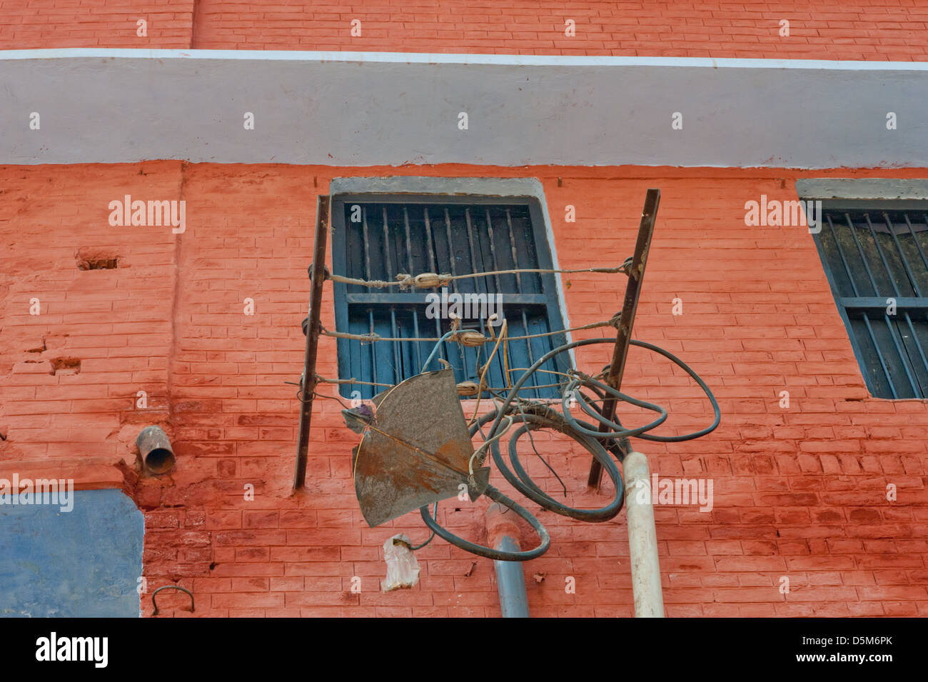 A paper kite caught on the side of a building. India. Stock Photo