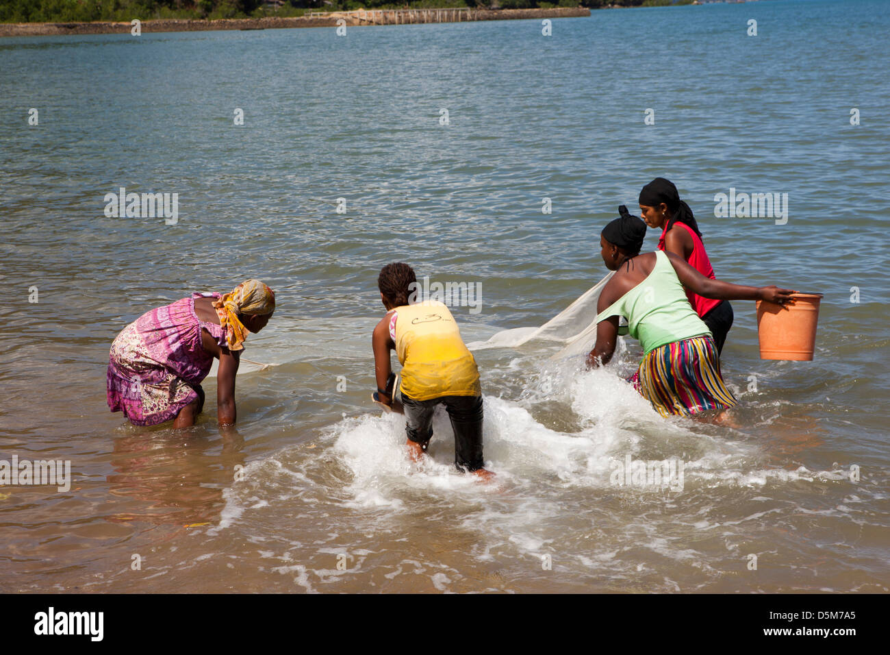 Madagascar, Nosy Be, Marodokana, women fishing in shallows at high tide Stock Photo