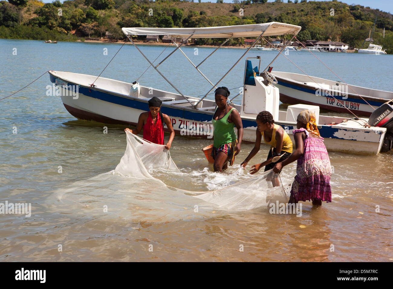 Madagascar, Nosy Be, Marodokana, women fishing in shallows at high tide Stock Photo