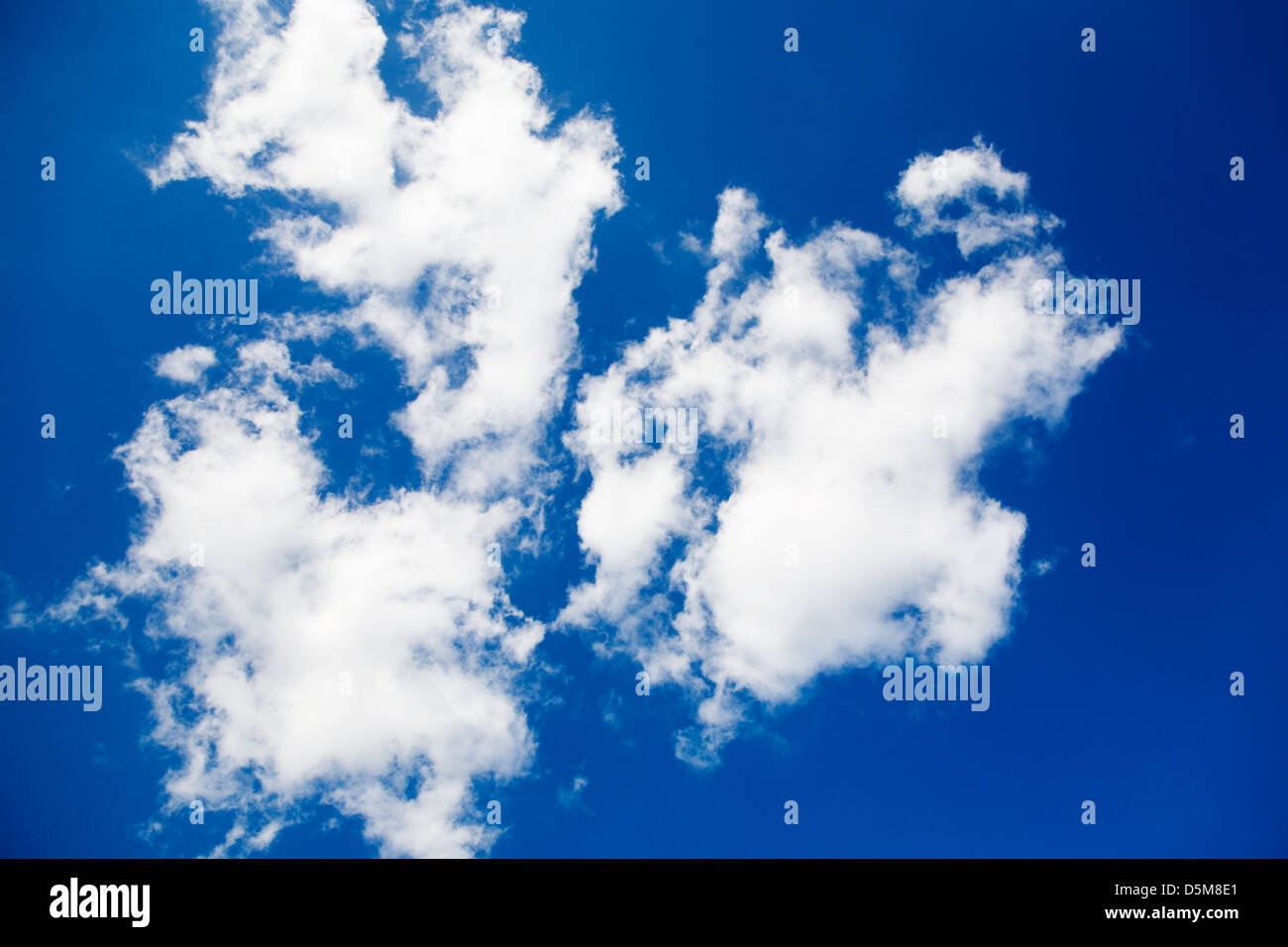 White fluffy clouds on bright blue sky Stock Photo - Alamy