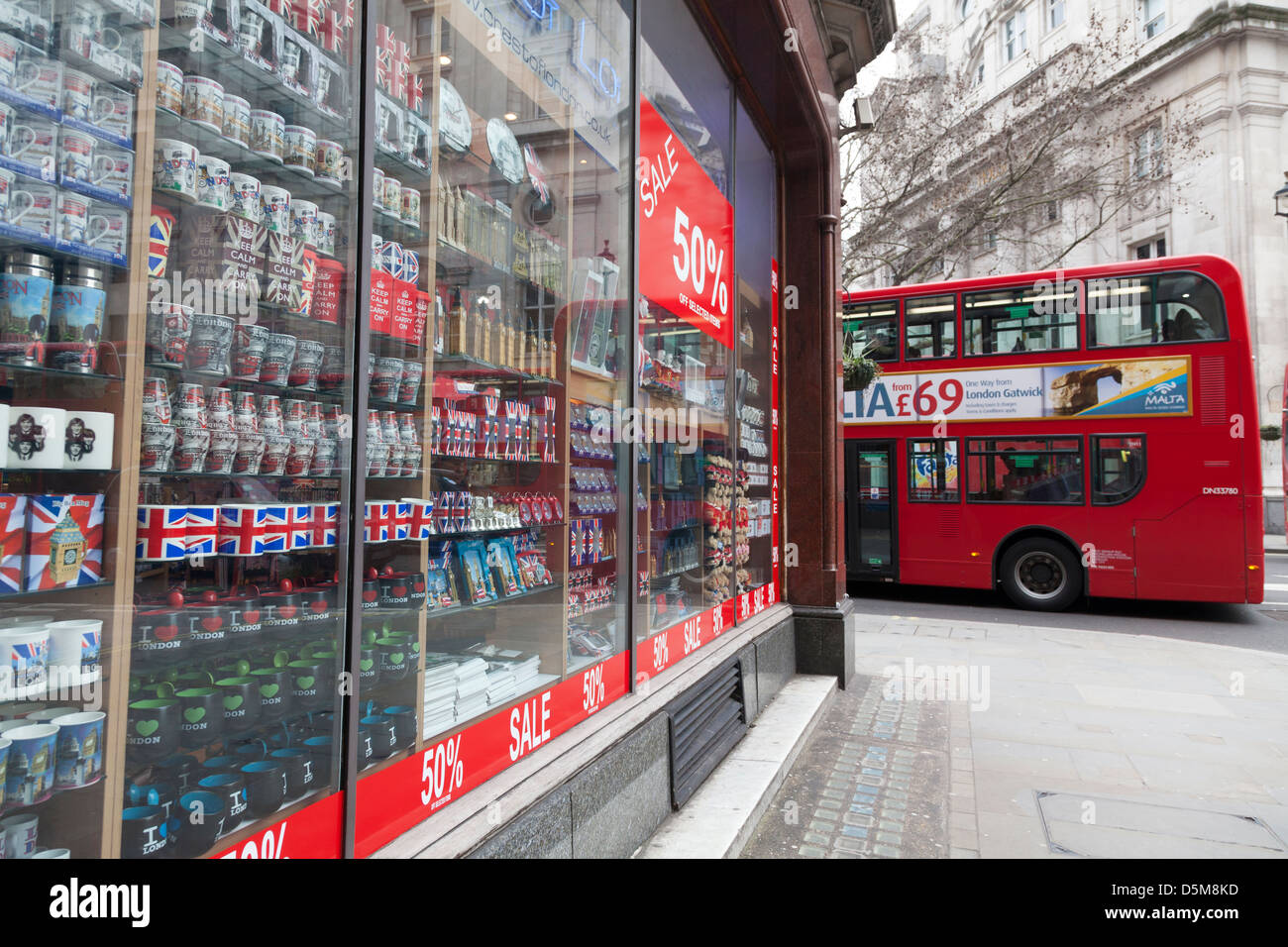 Tourist souvenirs in London shop window with 50% sale poster and double decker bus Stock Photo