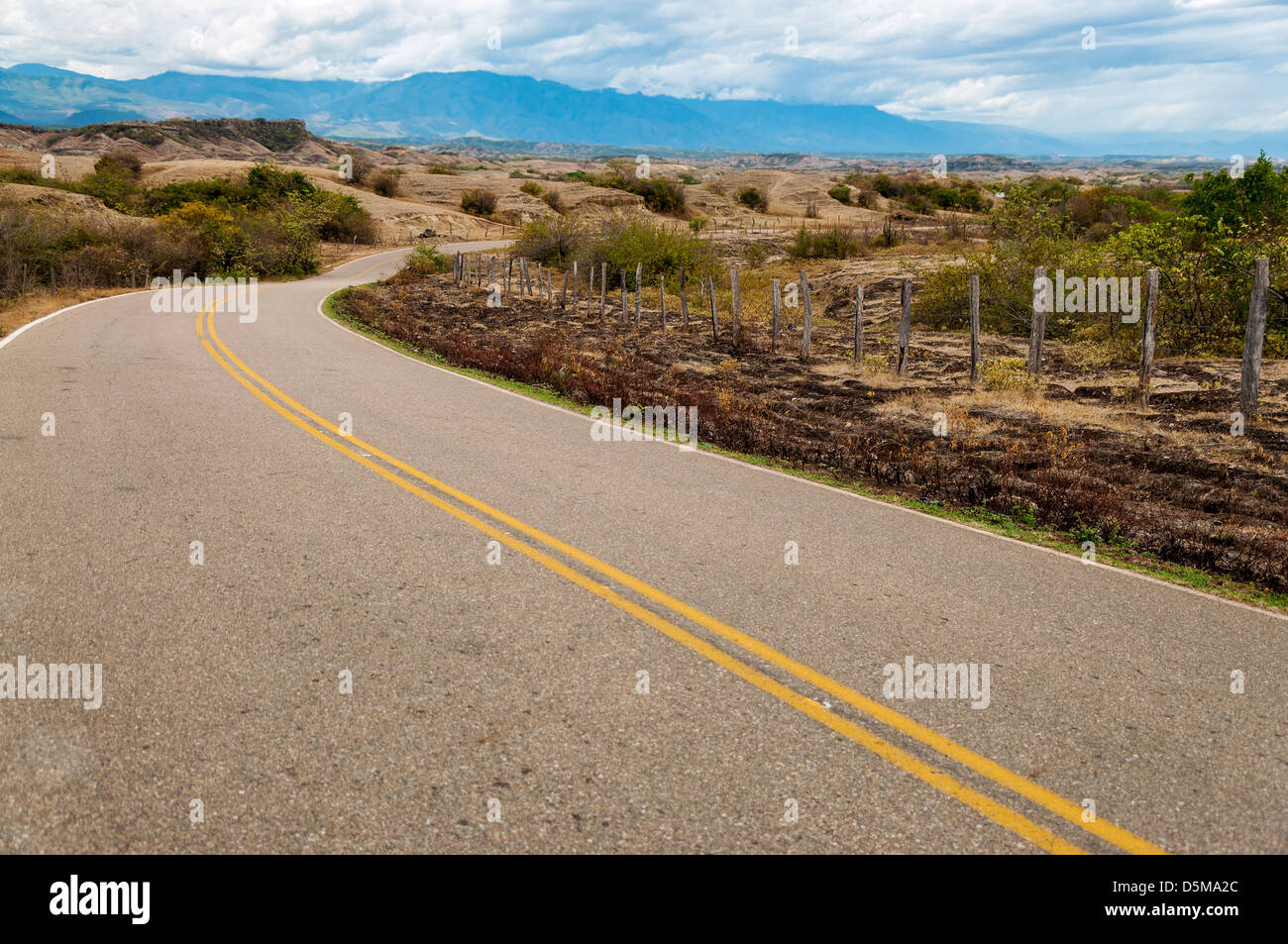 Long winding road through a dry arid landscape Stock Photo